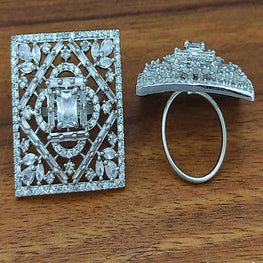 Silver brooch and ring on a wooden surface