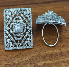 Silver brooch and ring on a wooden surface