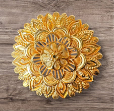 Decorative gold ring on a wooden surface